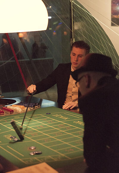 Roulette-Spieltisch bei der Weihnachtsfeier der Invoco Helpline GmbH Croupier zahlt Gewinne beim Roulette aus.